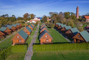 an aerial view of a village with houses and vineyards at Ośrodek Rekreacyjny Aga in Gąski