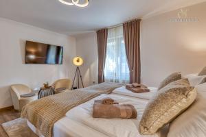 a bedroom with a large bed with towels on it at Apartment Nina Pazin in Pazin