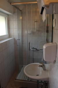a bathroom with a sink and a shower at Back Private Budget Rooms in Bled