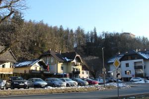een groep huizen en auto's geparkeerd op een parkeerplaats bij Back Private Budget Rooms in Bled