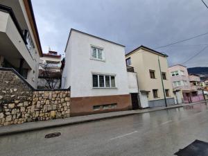 a white building on the side of a street at BASCARSIJA house in Sarajevo