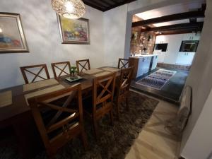 a dining room with a table and chairs and a kitchen at BASCARSIJA house in Sarajevo