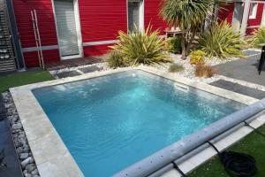 a swimming pool in the yard of a house at Nice house with pool near the city center in Hérouville-Saint-Clair