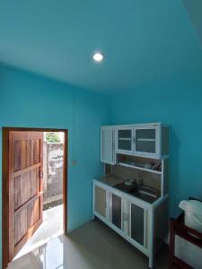 a bathroom with a sink and a blue ceiling at Chalisa Bukit House Lanta in Ban Mo Nae