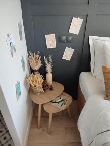 1 dormitorio con mesa junto a la cama en un nid d ' Amour, en Cabourg