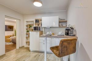 a kitchen with white cabinets and a counter top at Apartment Nina Pazin in Pazin
