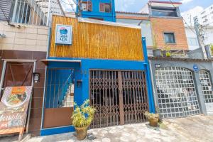 a blue building with a gate in front of it at Hostel Casa Azul in Sao Paulo