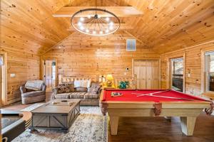 a living room with a pool table in a cabin at The Sly Fox - Recently Updated/ Ideal PF Location in Pigeon Forge