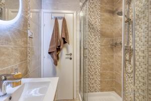 a bathroom with a shower and a sink and a tub at Apartment Nina Pazin in Pazin +15 photos