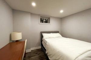 a bedroom with a bed and a desk and a bed sidx sidx sidx at Pearson airport and Toronto cozy stay - 2 bedroom in Vaughan