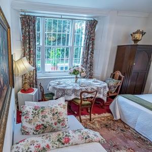 a dining room with a table and a window at Dawson Place, Juliette's Bed and Breakfast in London