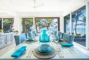 a dining room with a table with a blue vase on it at The Sandals By Edwards Collection in Hikkaduwa