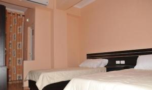 Postel nebo postele na pokoji v ubytování Garden Hotel
