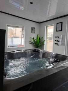 a bath tub with water in it in a room at Family Holiday with Hot tub , Family groups only in Blackpool