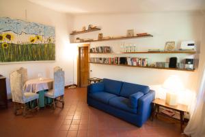 a living room with a blue couch and a table at The Palatine Garden Apartment in Rome