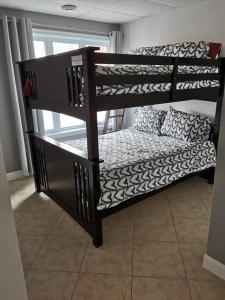 a set of bunk beds in a room at Chalet Au petit Édouard (Mont Édouard) in LʼAnse-Saint-Jean