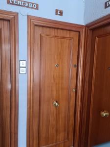 a pair of wooden cabinets in a room at Apartamento Zaragoza Plaza Europa in Zaragoza