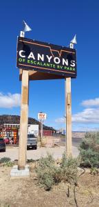a sign for a canyon of excellence iv ranch at Canyons Of Escalante RV Park in Escalante