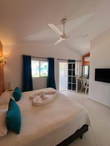 a bedroom with a bed with a towel on it at Hotel Casa Coson in Las Terrenas