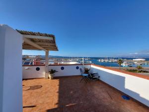 a balcony of a house with a view of the water at Perla del mare in Calasetta