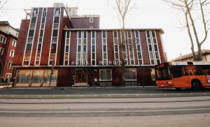 an orange bus parked in front of a building at Hotel Mondial in Marghera