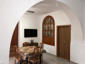 una sala da pranzo con un tavolo e una tv di Cortijo los Garridos - 6 huéspedes a Almería