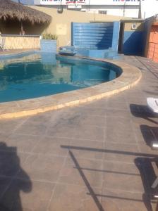 a swimming pool next to a house with at Hotel Rio Inn in Veracruz