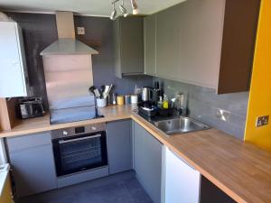 a small kitchen with a sink and a stove at Entire Loddon Apartment in Loddon