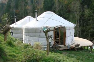 a couple of yurt tents sitting in a field at Casa Leon in Vrin