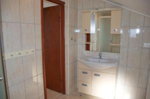a bathroom with a sink and a mirror at Apartments Summer Joy in Novalja +41 photos