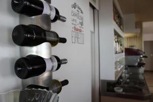 a bunch of wine bottles hanging on a wall at Hotel Kent in Riccione