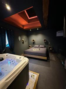 a bedroom with a bed and a bath tub at Bulle dore in Penne-dʼAgenais