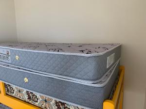 two blue suitcases stacked on top of each other at Apartamento Centro Frente Mar-Mongaguá in Mongaguá