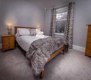 a bedroom with a large bed and a window at Spacious 1st Floor Apartment in Keswick