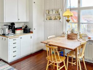 uma cozinha com uma mesa de madeira e cadeiras em Holiday home Edsbruk em Edsbruk