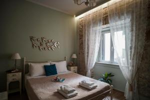 ein Schlafzimmer mit einem Bett mit zwei Handtüchern darauf in der Unterkunft Bruskos luxury in Korfu-Stadt