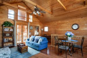 a living room with a blue couch and a table at Lovers Paradise Hot Tub Grill Fireplace in Sevierville