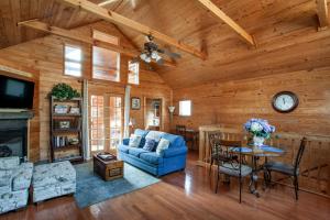a living room with a blue couch and a table at Lovers Paradise Hot Tub Grill Fireplace in Sevierville