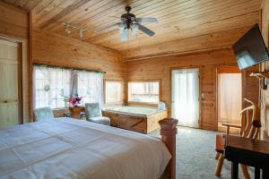 a bedroom with a bed and a tub in a room at Lovers Paradise Hot Tub Grill Fireplace in Sevierville