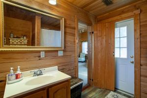 a bathroom with a sink and a mirror at Lovers Paradise Hot Tub Grill Fireplace in Sevierville +41 photos