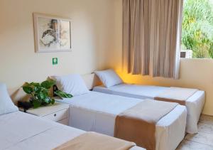 Un ou plusieurs lits dans un hébergement de l'établissement Hotel Harbor Inn Londrina