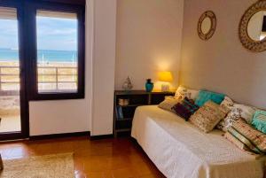 a bedroom with a bed with a view of the ocean at Vistas al Mar in Somo