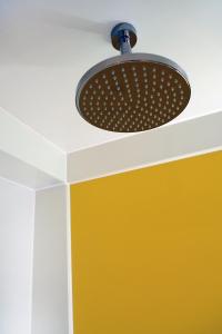 a ceiling light hanging from a ceiling at The Corner London City in London