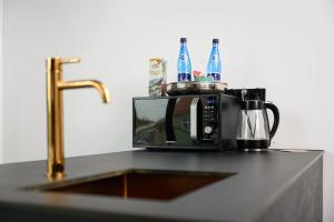 a microwave sitting on a counter next to a sink at Rich Sopot by OneApartments in Sopot