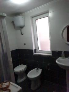 ナポリにあるLovely Glaucus's cottageのバスルーム(トイレ、洗面台付)、窓が備わります。