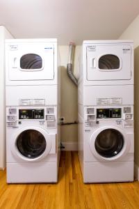 two washing machines are stacked on top of each other at West Broadway Quarters by Thatch in Boston