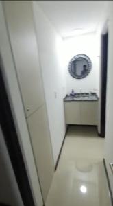 Baño blanco con lavabo y espejo en VENETO VILLAGE en Villa Carlos Paz