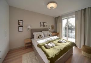 Posteľ alebo postele v izbe v ubytovaní Apartament Dziwnów Sagaris Spa