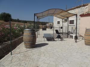a patio with a barrel and a pavilion at Agriturismo Il Tenimento in Ispica