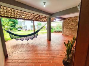 a porch with a hammock in a house at Pousada Villa Magna - Suite in Diamantina